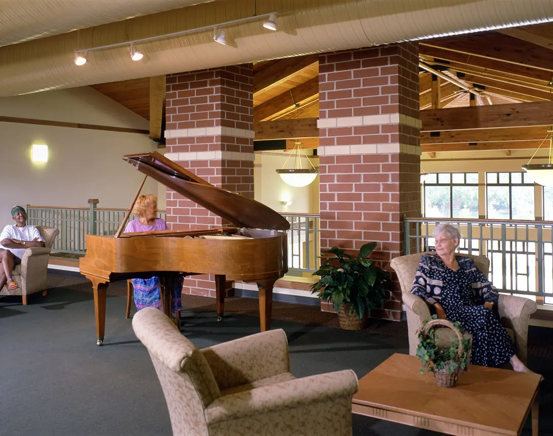 Bernardin Manor resident lounge with piano and seating