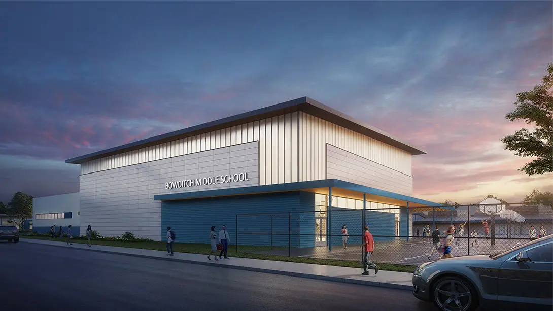 Modern Bowditch Middle School building at sunset with people outside, highlighting its sleek architecture.