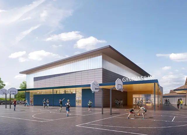 Modern gymnasium exterior with outdoor basketball courts and players under a clear blue sky.