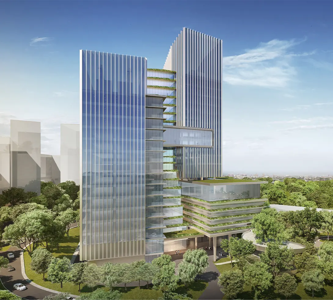 Modern skyscraper with glass facade surrounded by trees, featuring interconnected towers under a clear blue sky.
