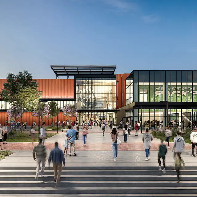 Modern campus entrance with students walking on a sunny day, featuring a sleek design of glass and brick architecture.