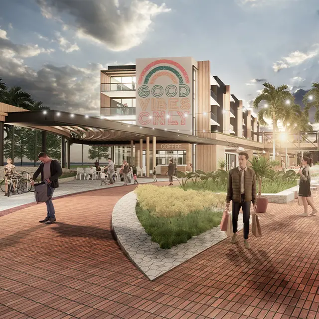 Modern shopping plaza with Good Vibes Only sign, outdoor seating, and people walking under a cloudy sky.