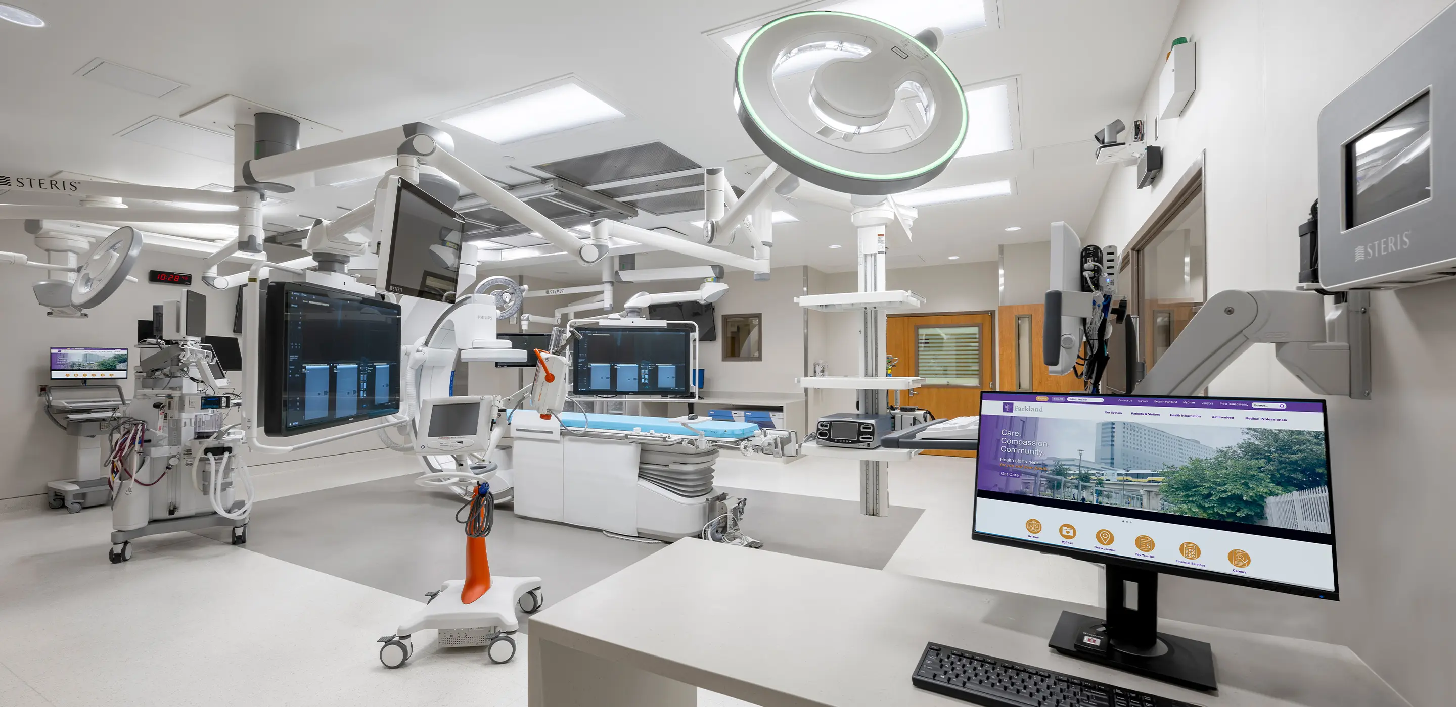 Modern operating room with advanced medical equipment and monitors.