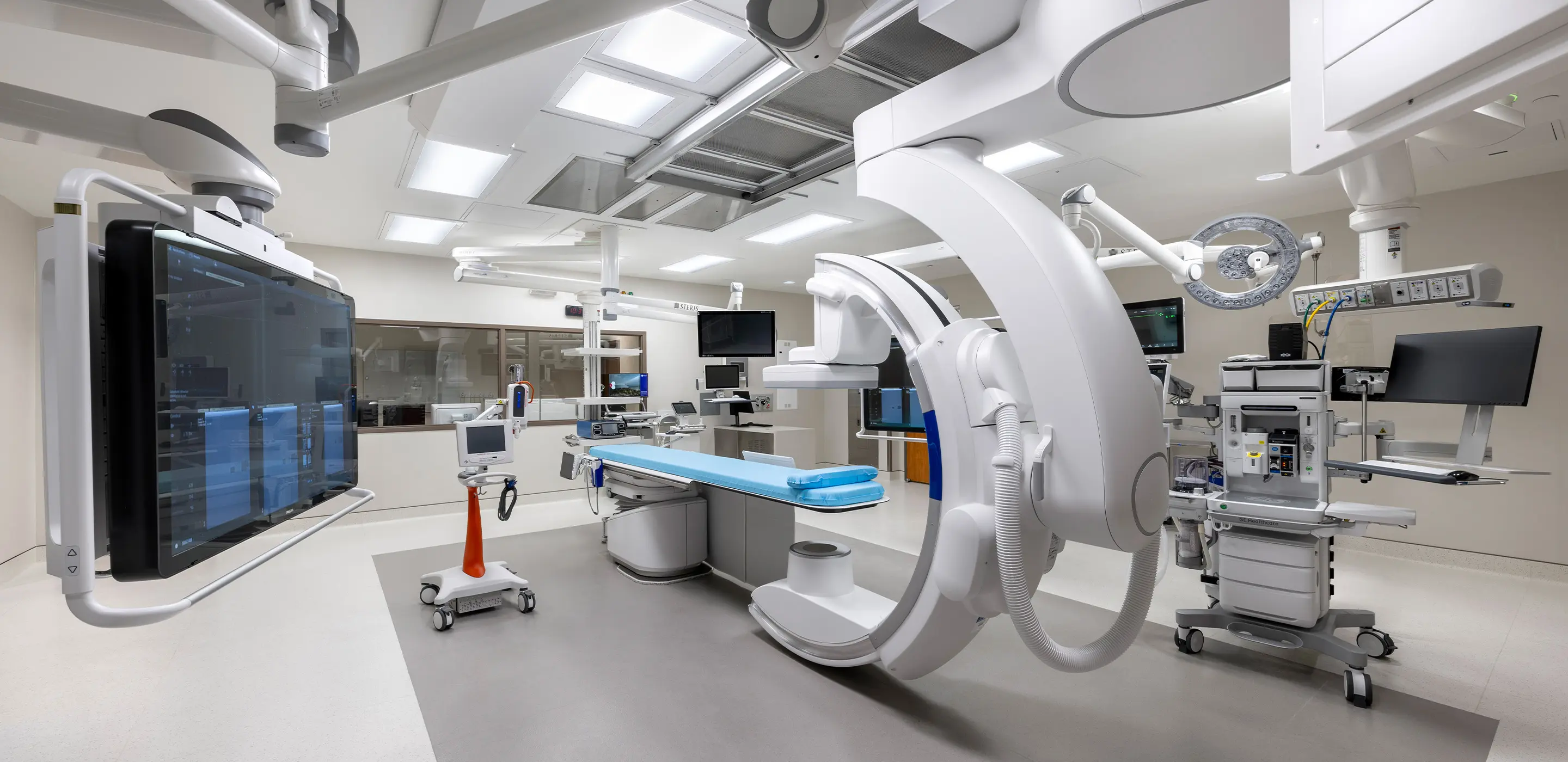 Modern hospital operating room equipped with advanced medical technology and monitoring systems.