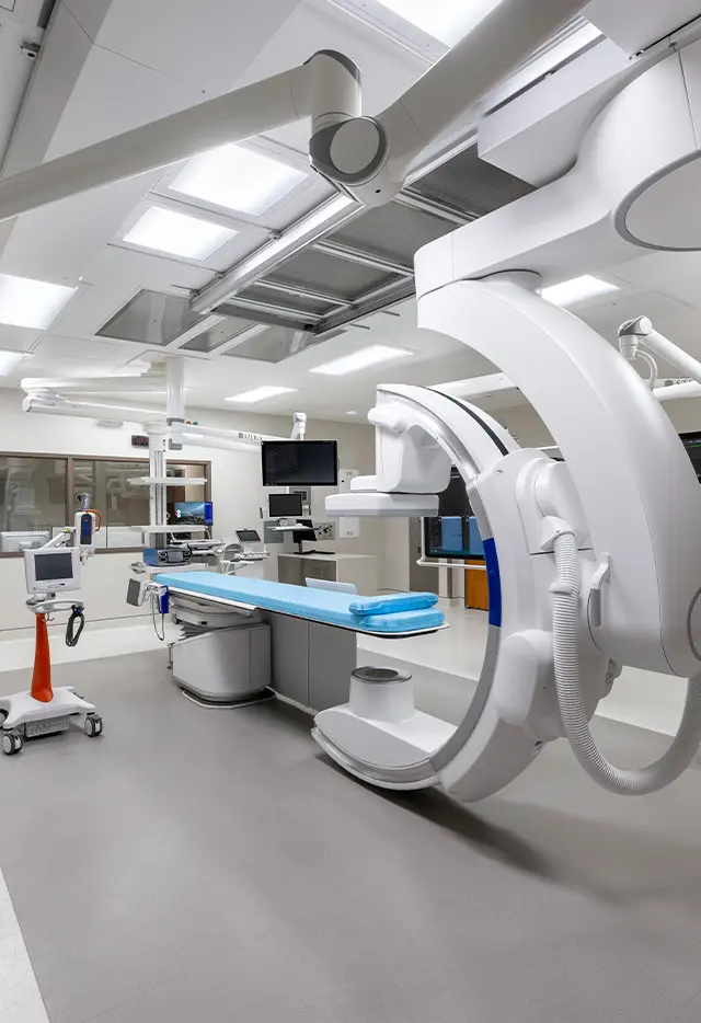 Modern hospital operating theater with advanced surgical equipment and lighting.