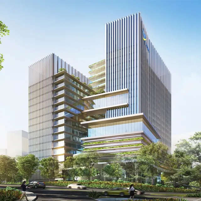 Modern office building with glass facade and greenery on terraces under a clear blue sky.
