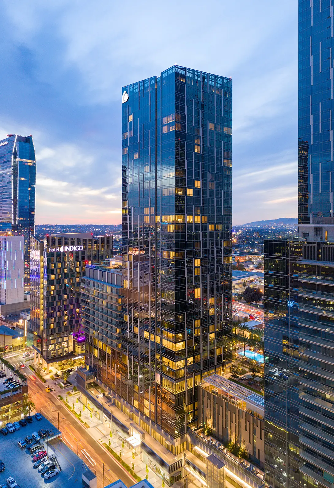 Skyscraper view at dusk in downtown Los Angeles with lit windows and evening cityscape.