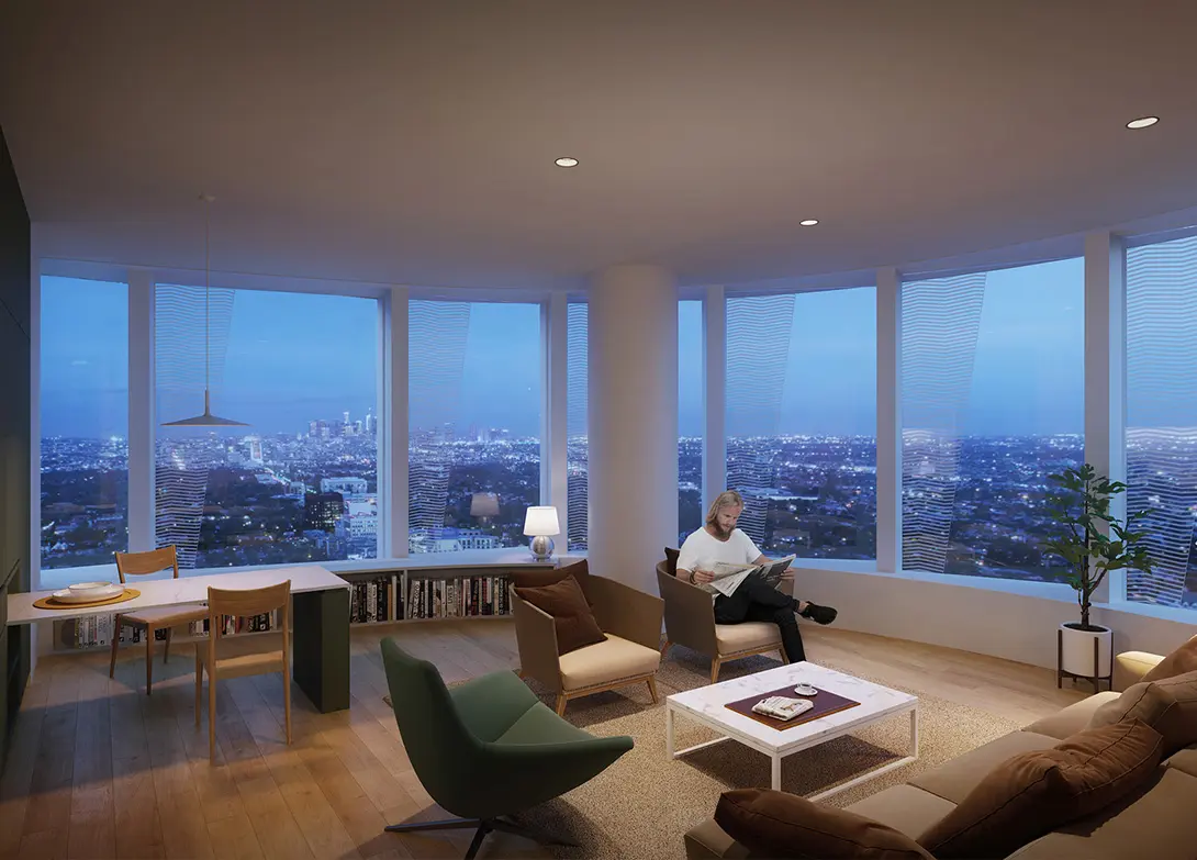 Man reading in modern living room with city skyline view through large windows at dusk.