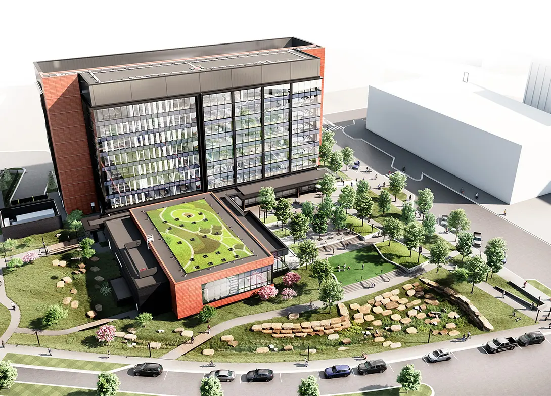 Modern office building with a green rooftop garden and surrounding trees, showcasing eco-friendly architecture design.