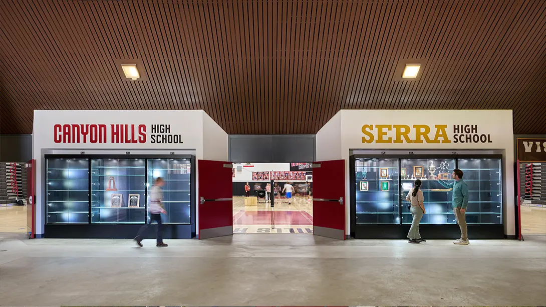 Canyon Hills vs. Serra High School entrance with trophy display cases inside a gymnasium.