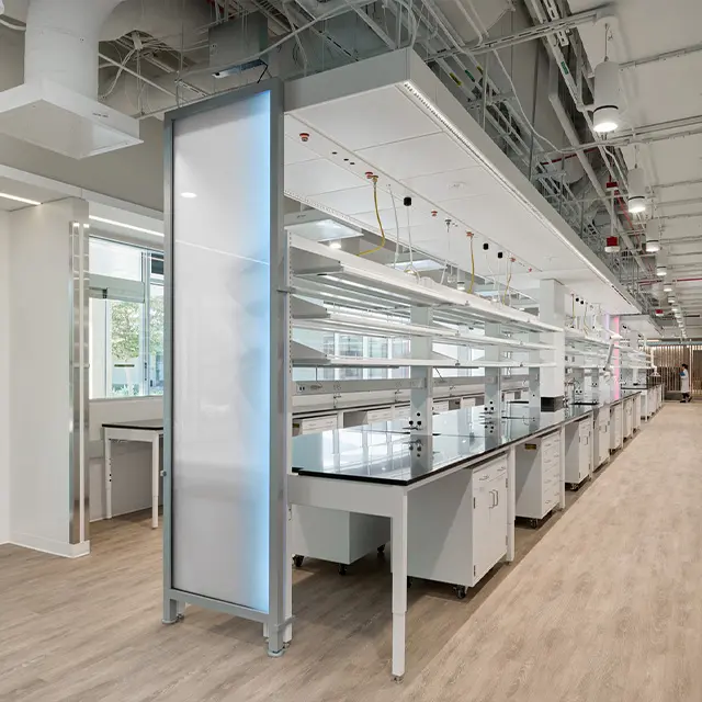 Modern laboratory with advanced workstations and equipment in a bright, spacious setting.