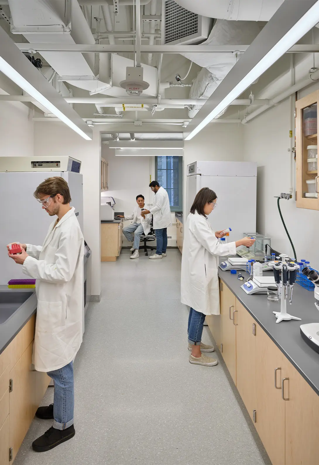 Scientists in a modern laboratory conducting experiments and analyzing results.