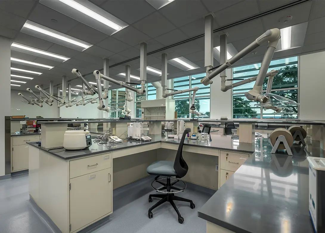 Modern laboratory with workstations and ventilation systems in a bright, spacious lab environment.